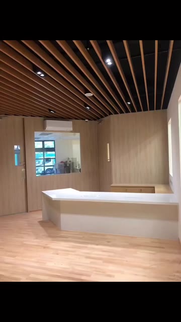 Reception fit-out with slatted timber ceiling and wood panelling