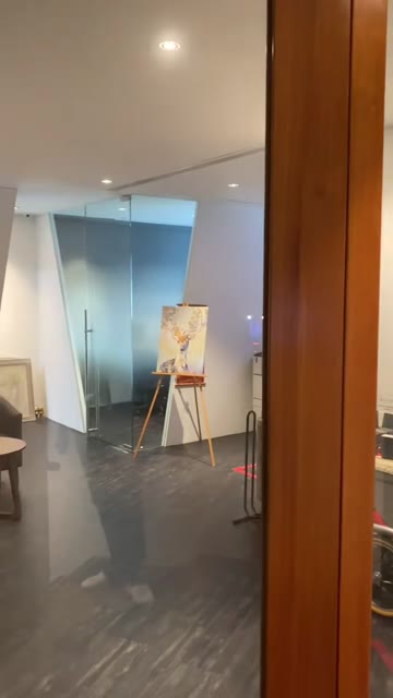 Studio interior with angled glass partitions and gallery spotlighting